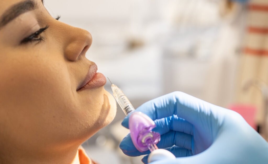 Young woman getting lip injections at a medical spa