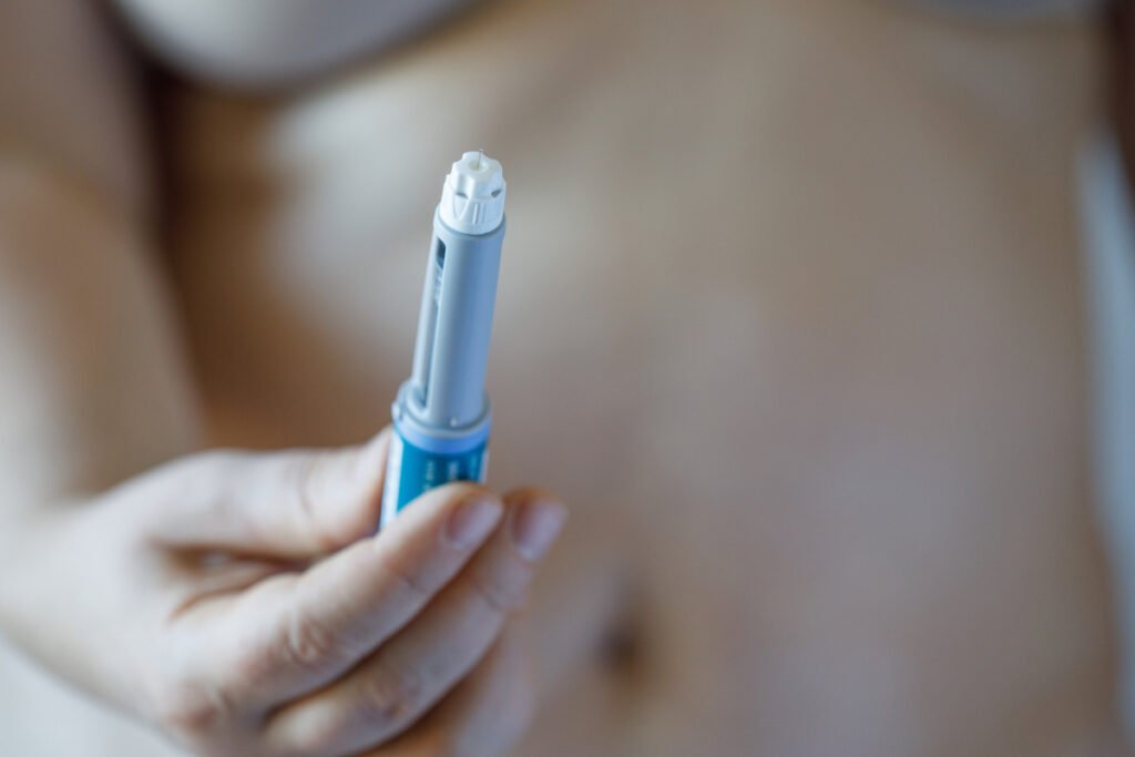 Woman holding semaglutide injection pen for medical weight loss 