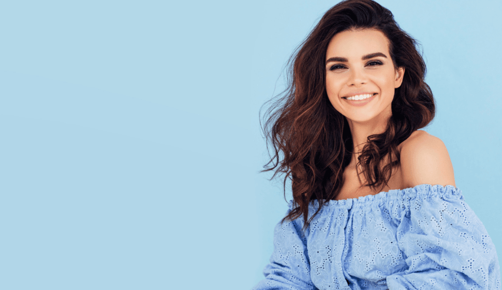 Woman smiling against blue background