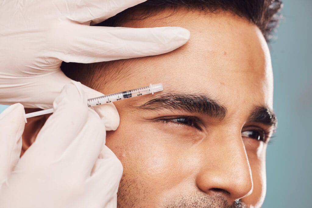 Close up of man getting forehead injections also known as Brotox