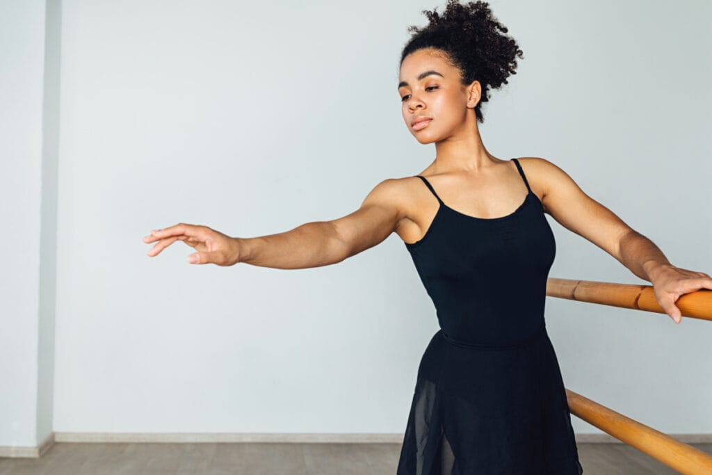 Woman stretching with ballet barre